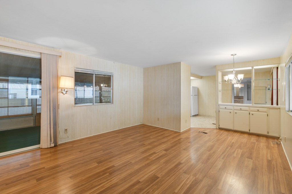 A room with wooden floors and white walls.