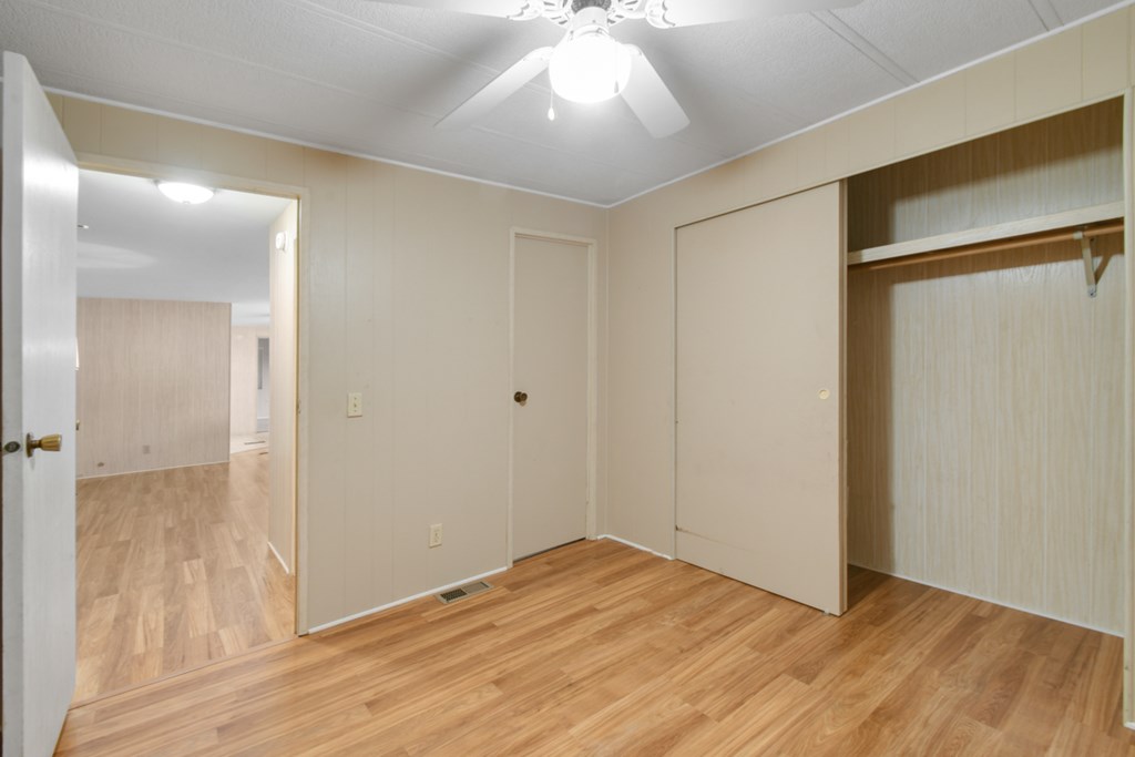 A room with wooden floors and white walls.