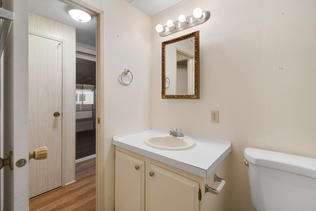 A white sink with a mirror above it.