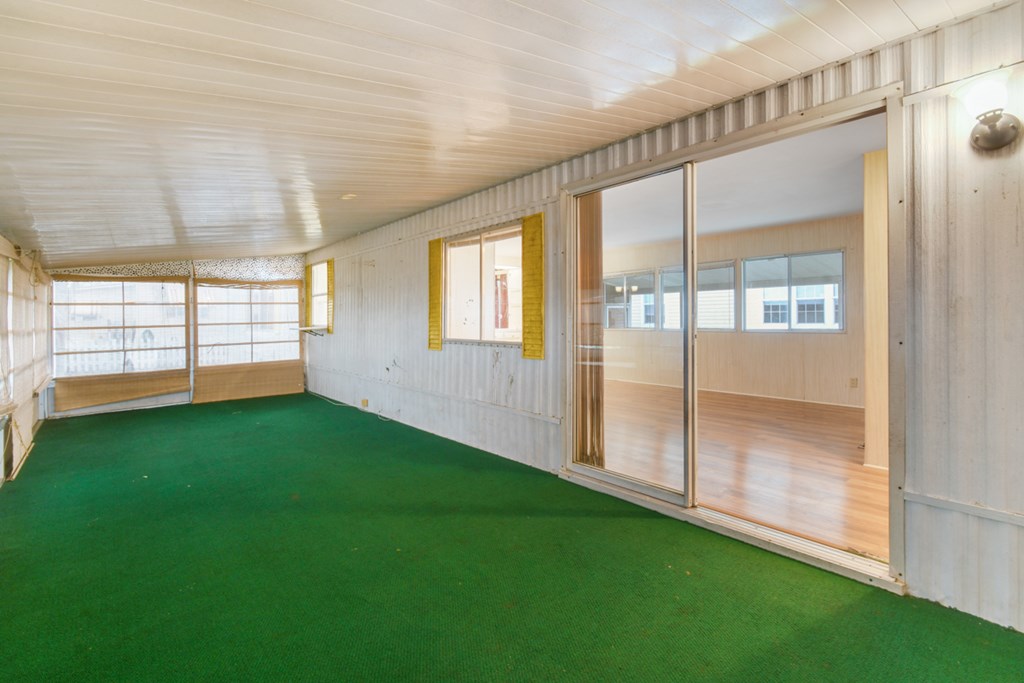 A room with a green floor and white walls.