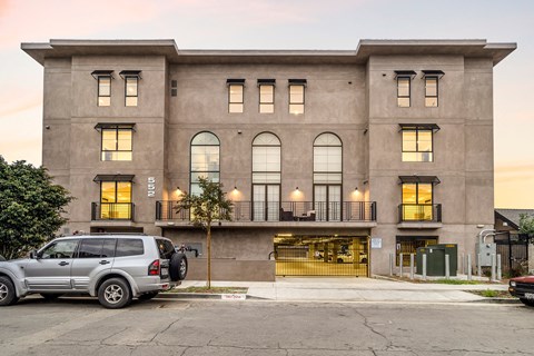 the front of a building with a car parked in front