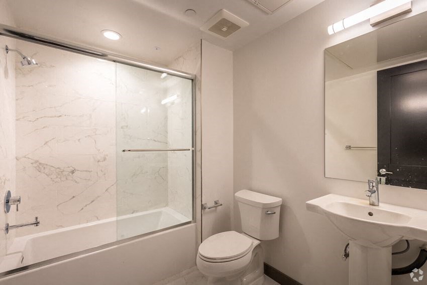 a bathroom with a toilet and a sink and a shower