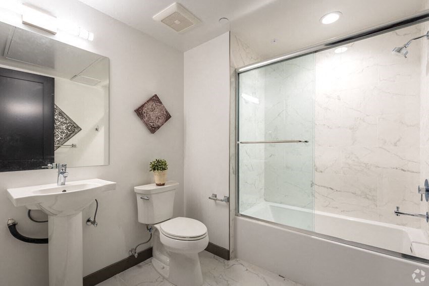 a bathroom with a toilet sink and a shower