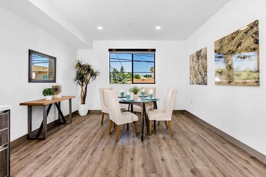 a dining room with a table and chairs