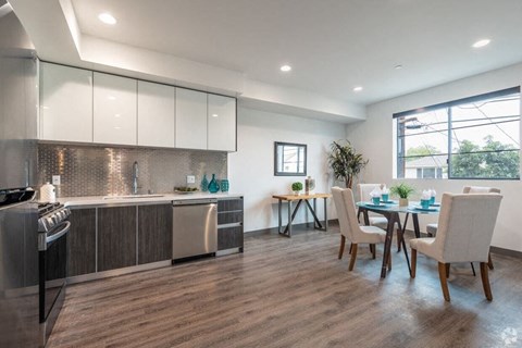 a kitchen and dining room with a table and chairs