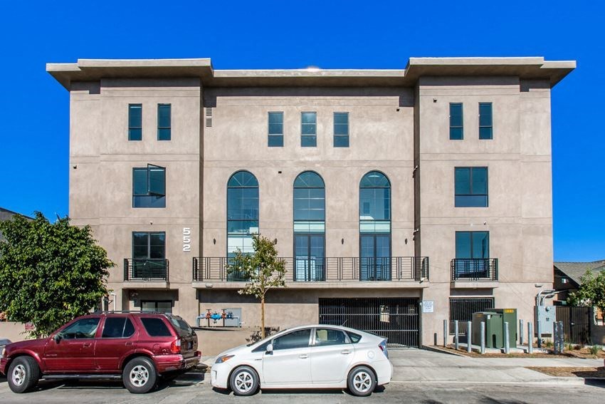a building with two cars parked in front of it
