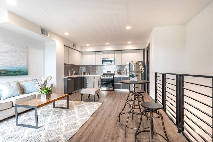 a living room with a bar and a kitchen