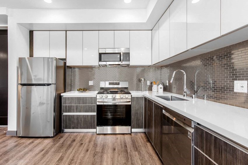 a kitchen with stainless steel appliances and white cabinets