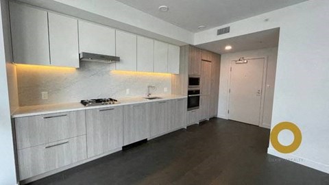 a large white kitchen with white cabinets and a door