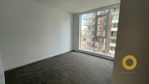 an empty living room with a large window