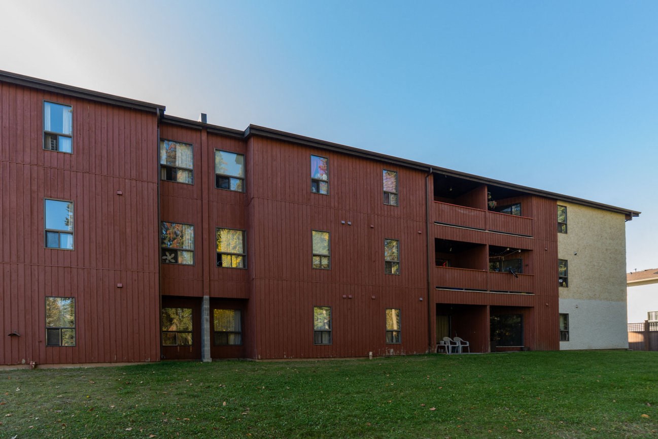 the exterior of a building with green grass