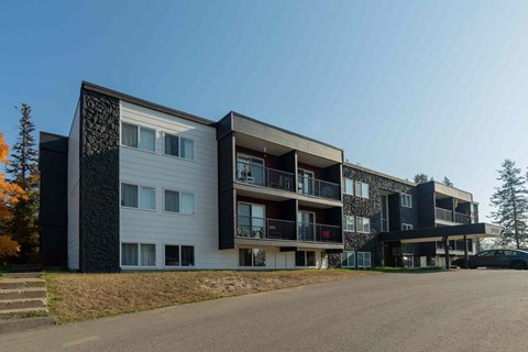 a view of the exterior of a modern apartment building
