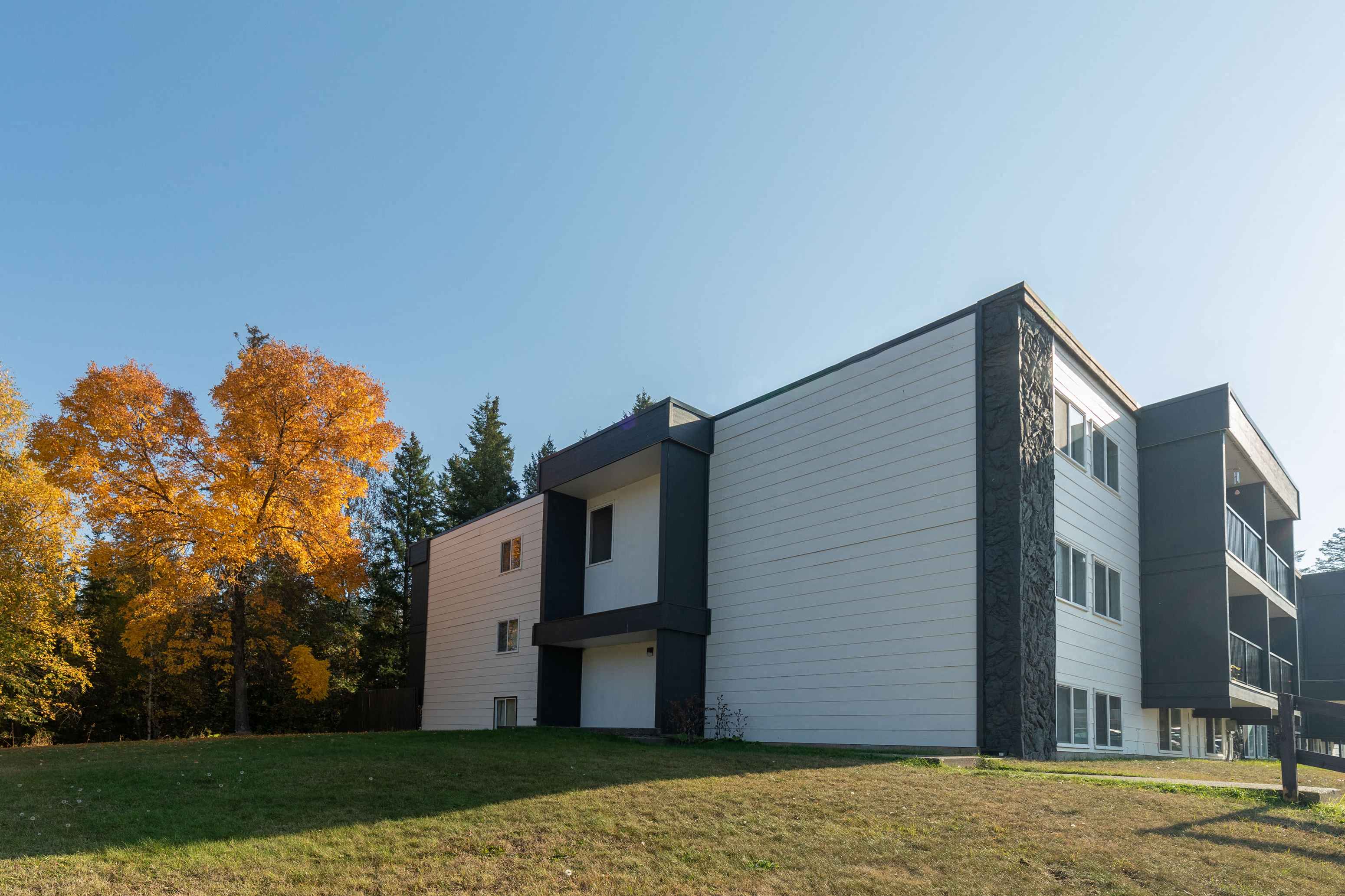 a modern building with a lawn in front of it