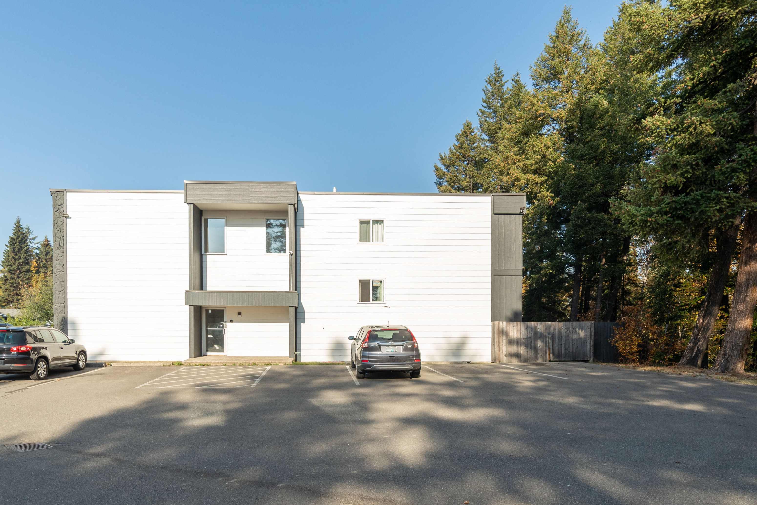 a white building with a car parked in front of it