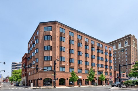 a large brick building on the corner of a city street