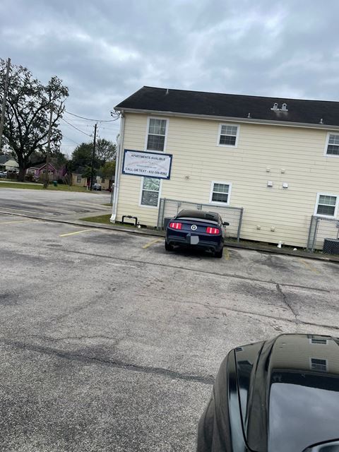 a car parked in a parking lot in front of a building