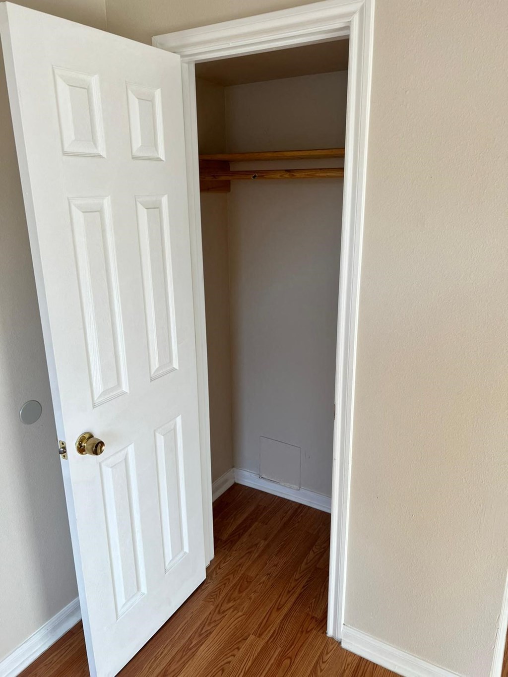 an empty room with a closet and a door open
