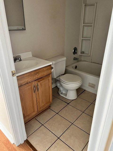 a bathroom with a toilet and a sink and a bath tub