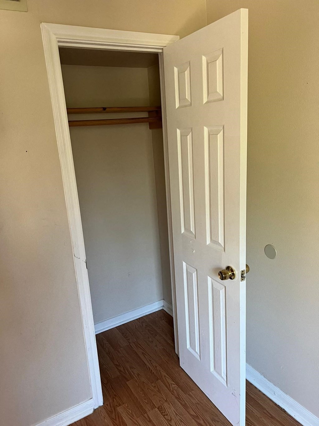 a room with a door open to a closet and a door to a hallway