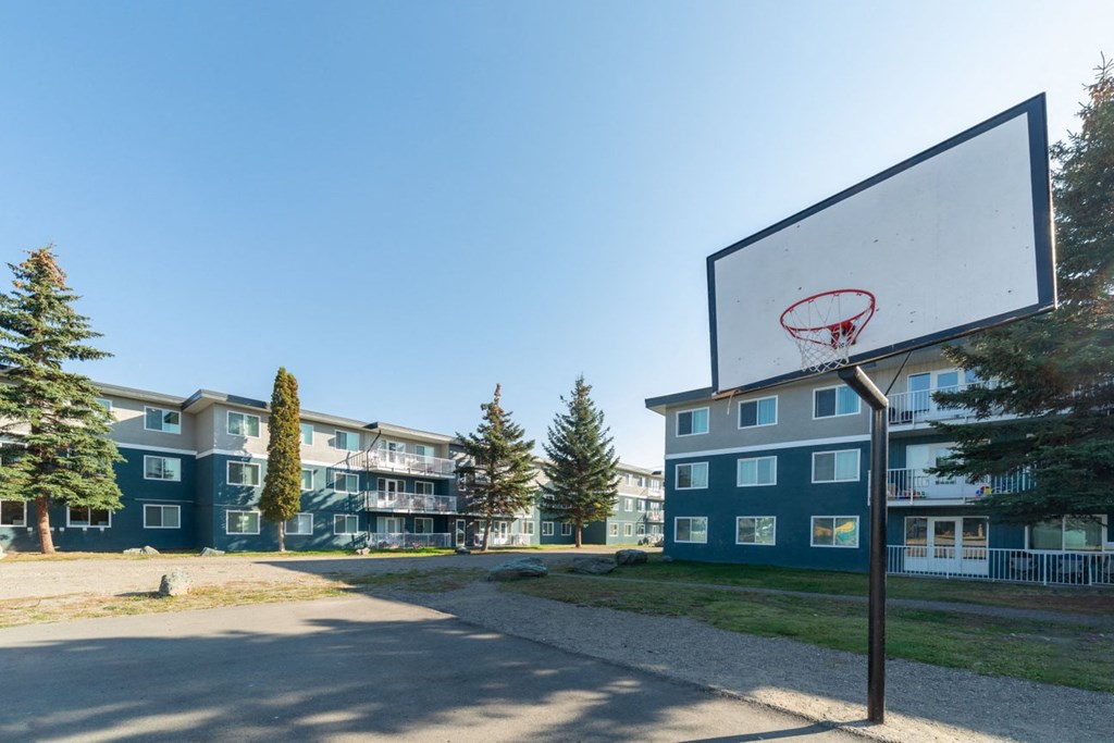 a basketball hoop in front of an apartment building