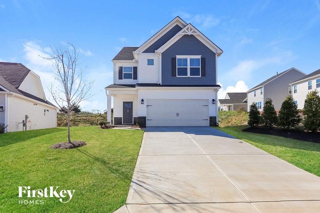 A house with a driveway in front of it and the words "FirstKey Homes" on the bottom left.