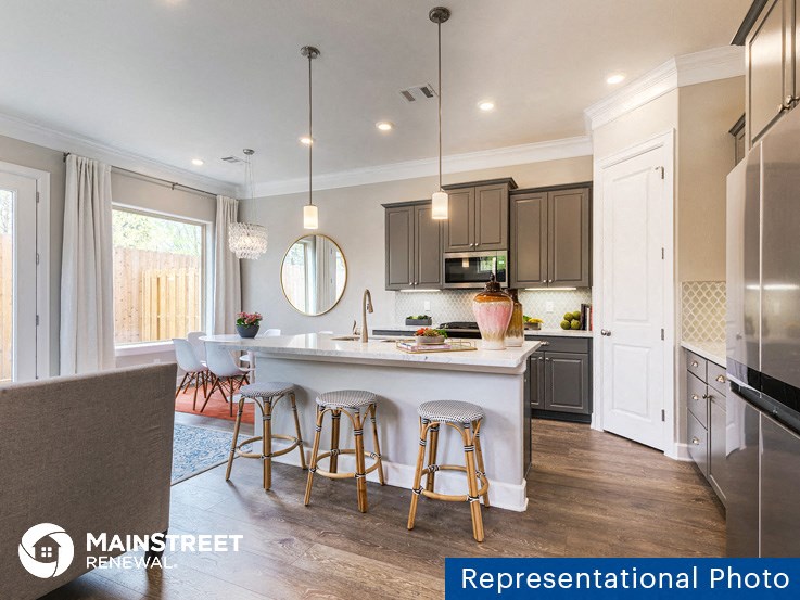 an image of a kitchen with a bar and stools