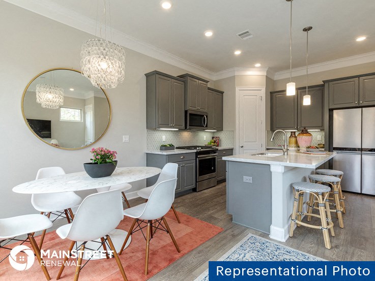 an image of a kitchen and dining room with a white table and chairs