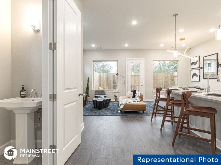 an open kitchen and living room with a dining room and a living room