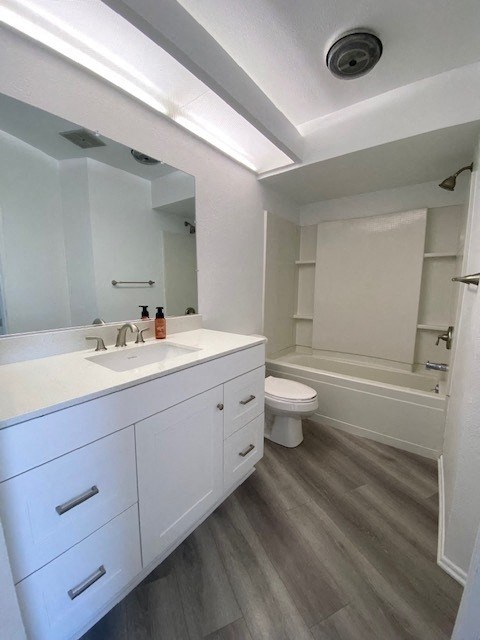 a white bathroom with a sink and a toilet