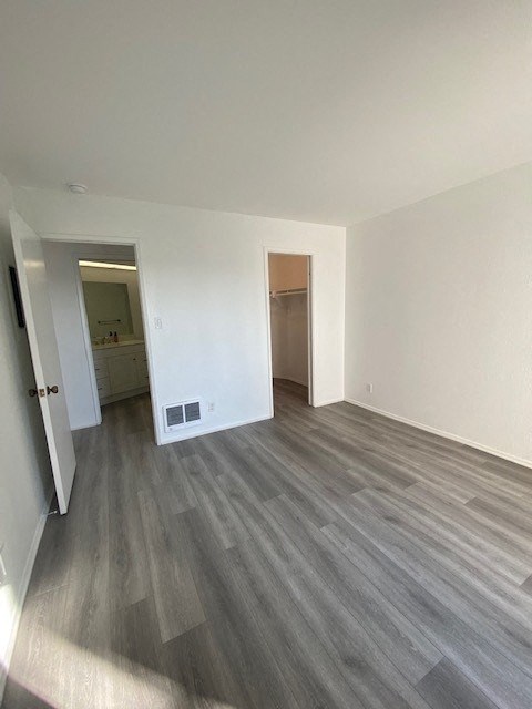 an empty living room with wood flooring and white walls