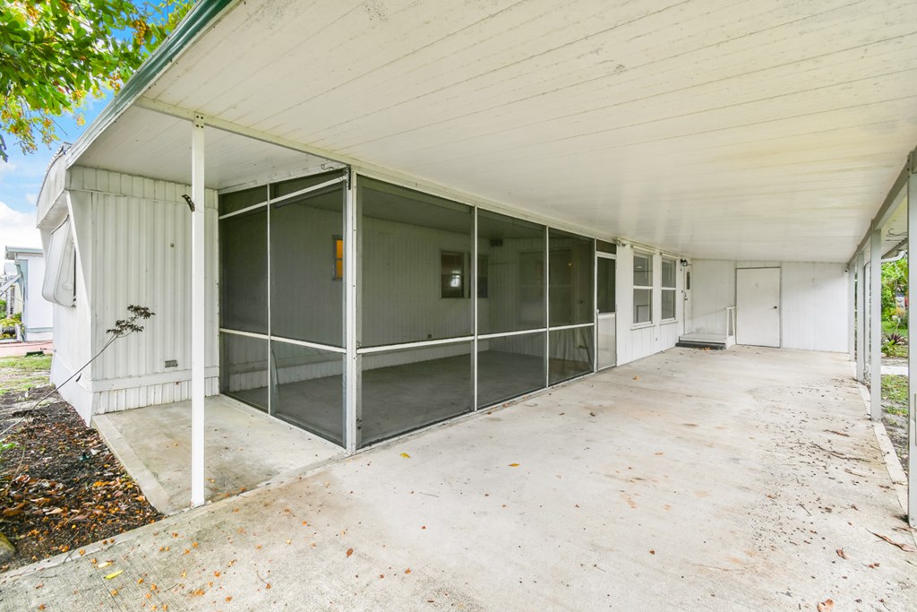 A long white building with glass doors and windows.
