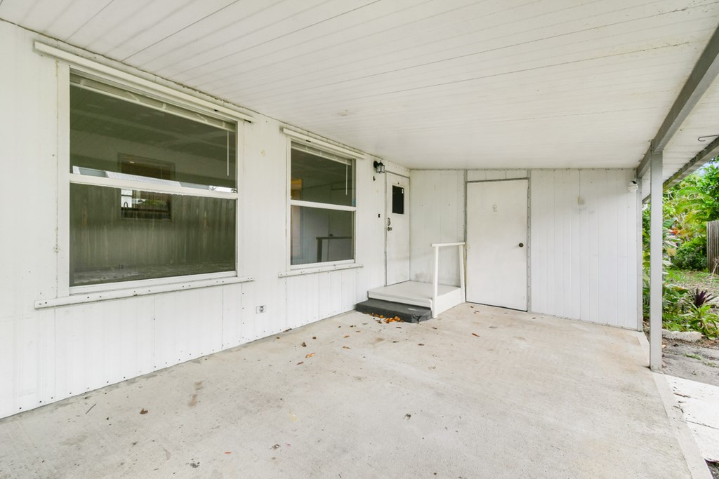 A white room with a door and a window.
