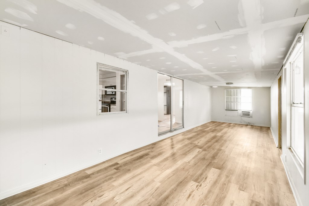 A room with wooden floors and white walls.
