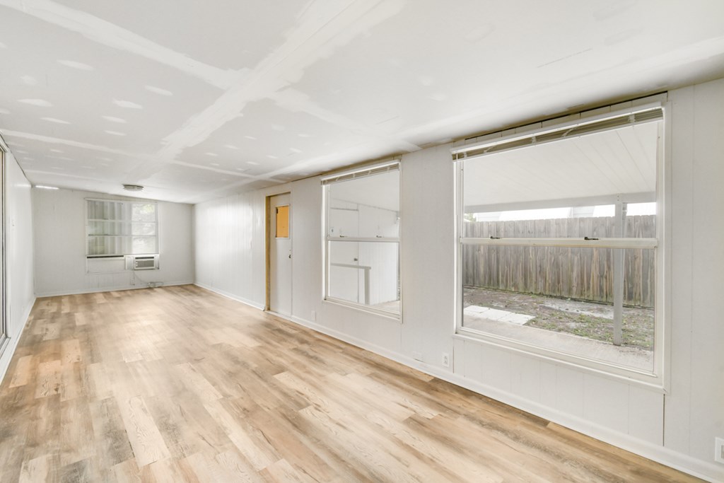 A room with wooden floors and white walls.
