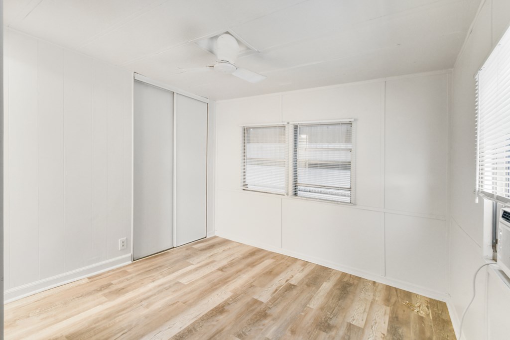 A room with a sliding door and a window.