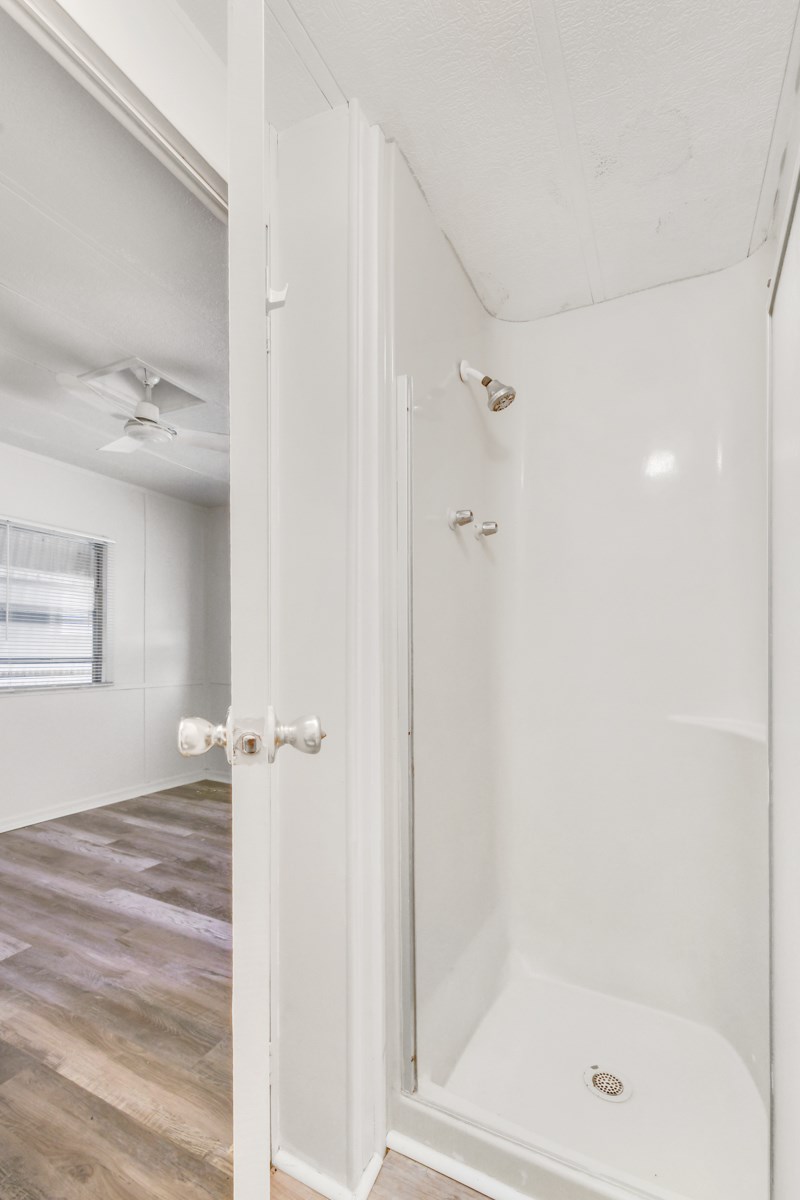 A white door is open to a bathroom.