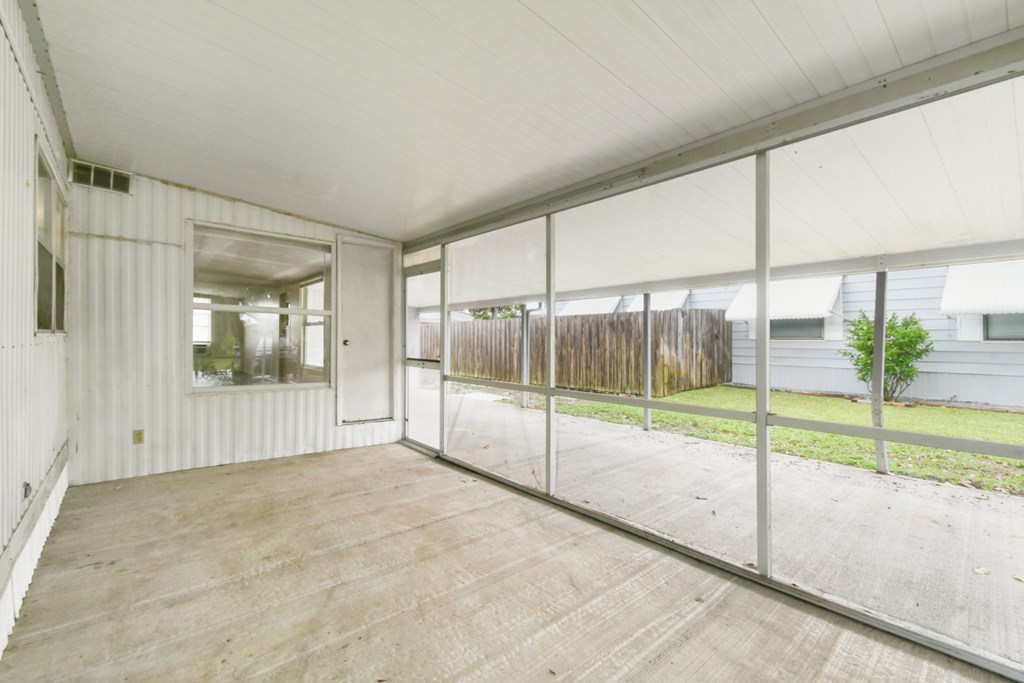 A room with a white ceiling and a wooden floor.