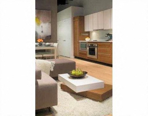 A modern kitchen with a dining table and chairs.