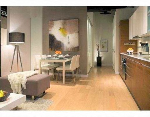 A modern living room with a dining table and chairs.
