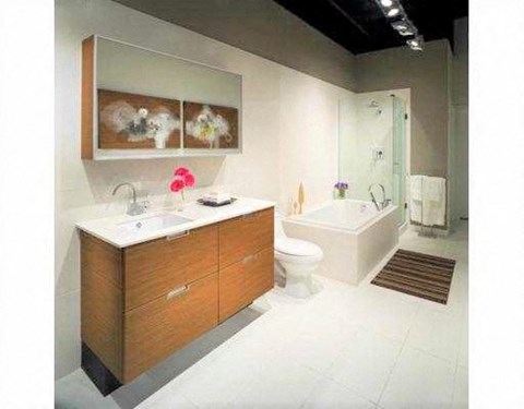A modern bathroom with a white countertop and a brown cabinet.