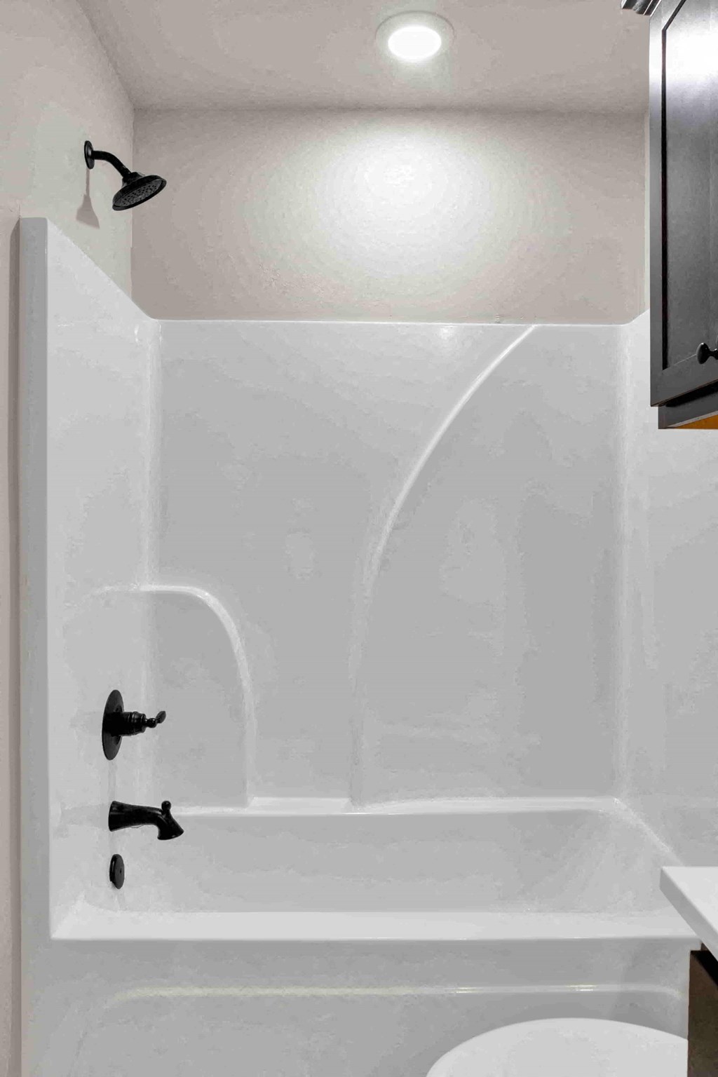 a white bathroom with a tub and a sink