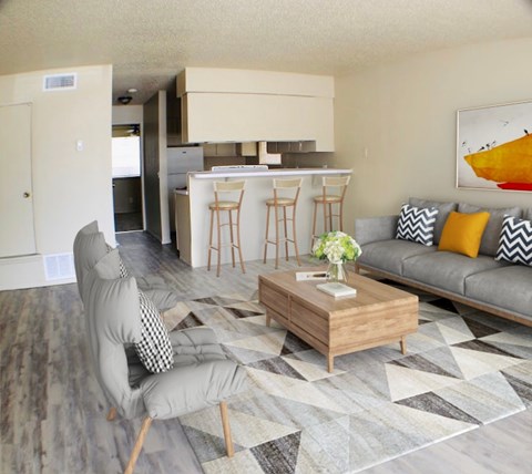 A living room with a grey couch and a grey chair.