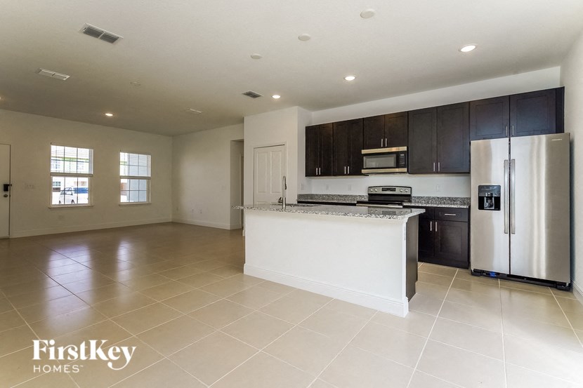 a kitchen with a white counter top and a refrigerator