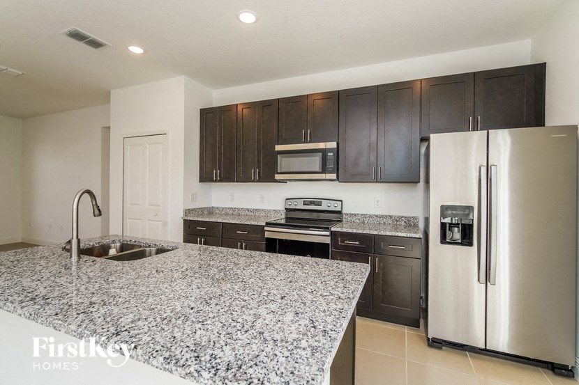 a kitchen with granite counter tops and stainless steel appliances
