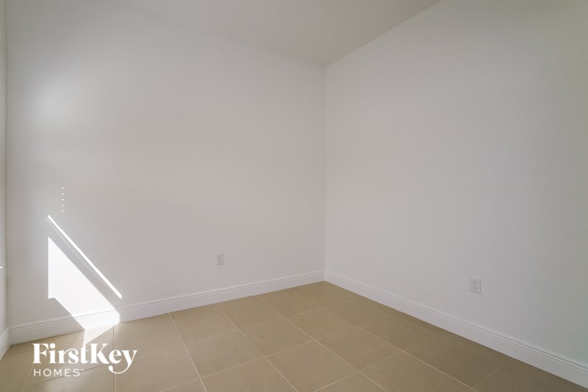 a empty room with white walls and a tiled floor