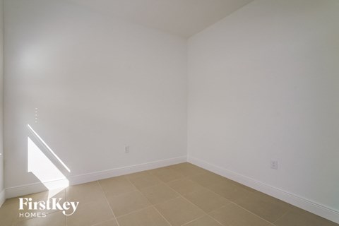 a empty room with white walls and a tiled floor