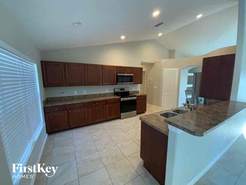 A kitchen with brown cabinets and a countertop.