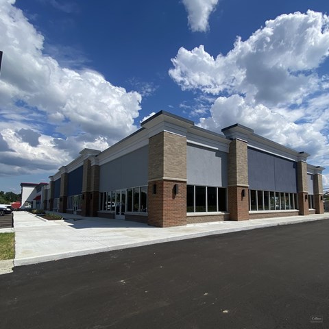 an empty building with a blue cloudy sky in the background