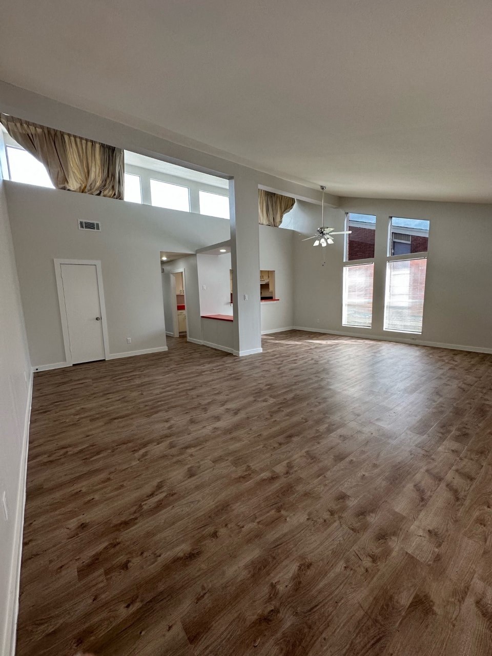 A room with wooden flooring and white walls.