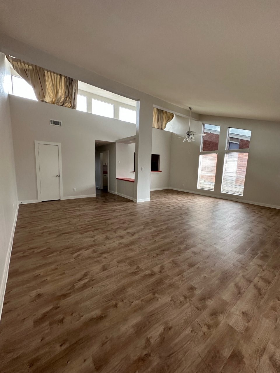 A room with wooden flooring and white walls.